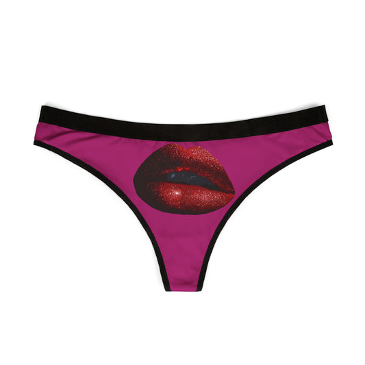 Elegant women's thong showcasing a bold lip print on a rich pink fabric, perfect for playful and intimate gifting.