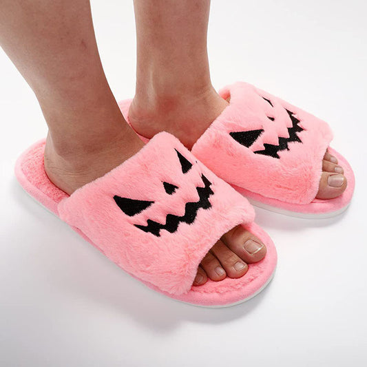 Halloween Shoes Winter Cute Warm Home Slippers for women in soft pink fur, showcasing a charming pumpkin face, perfect for adding warmth and style to your winter home attire.