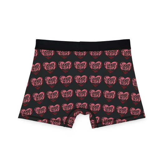 Back view of Valentine's Naughty Cheeky Men's Boxer Briefs showcasing 'I LICKED IT SO IT'S MINE' design in heart graphics on a black background.
