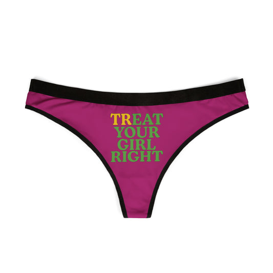 Elegant view of a women's thong in rich pink with striking black trim, displaying the humorous phrase 'Treat Your Girl Right' in eye-catching typography.