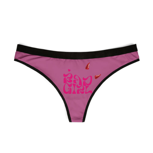 Sleek flat lay of hot pink Bad Girl thong panties, featuring playful devil horn design, ideal for bold fashion statements.