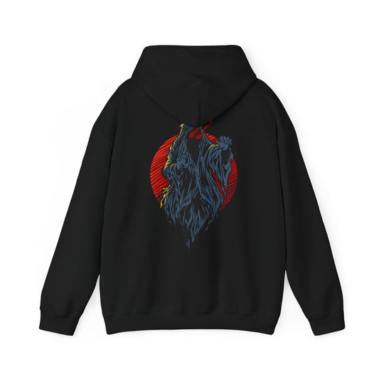 Back view of a luxurious black hoodie featuring a striking demon design in vivid grey and yellow against a fiery red circle, perfect for a bold and edgy style.