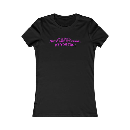 Black women's t-shirt featuring an eye-catching slogan, 'IT'S OKAY, THEY ARE STARING AT YOU TOO!' in vibrant pink lettering, designed for a confident and stylish look.