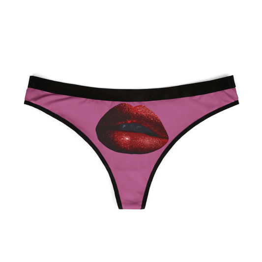 Luxurious women's thong featuring a dazzling graphic design of shiny red lips on a vibrant pink background, ideal for adding playful romance to any intimate occasion.