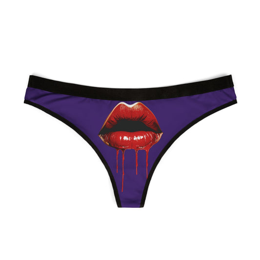 Front view of a luxurious women's thong showcasing a bold graphic design of red lips with dripping liquid, ideal for adding a cheeky touch to intimate moments.