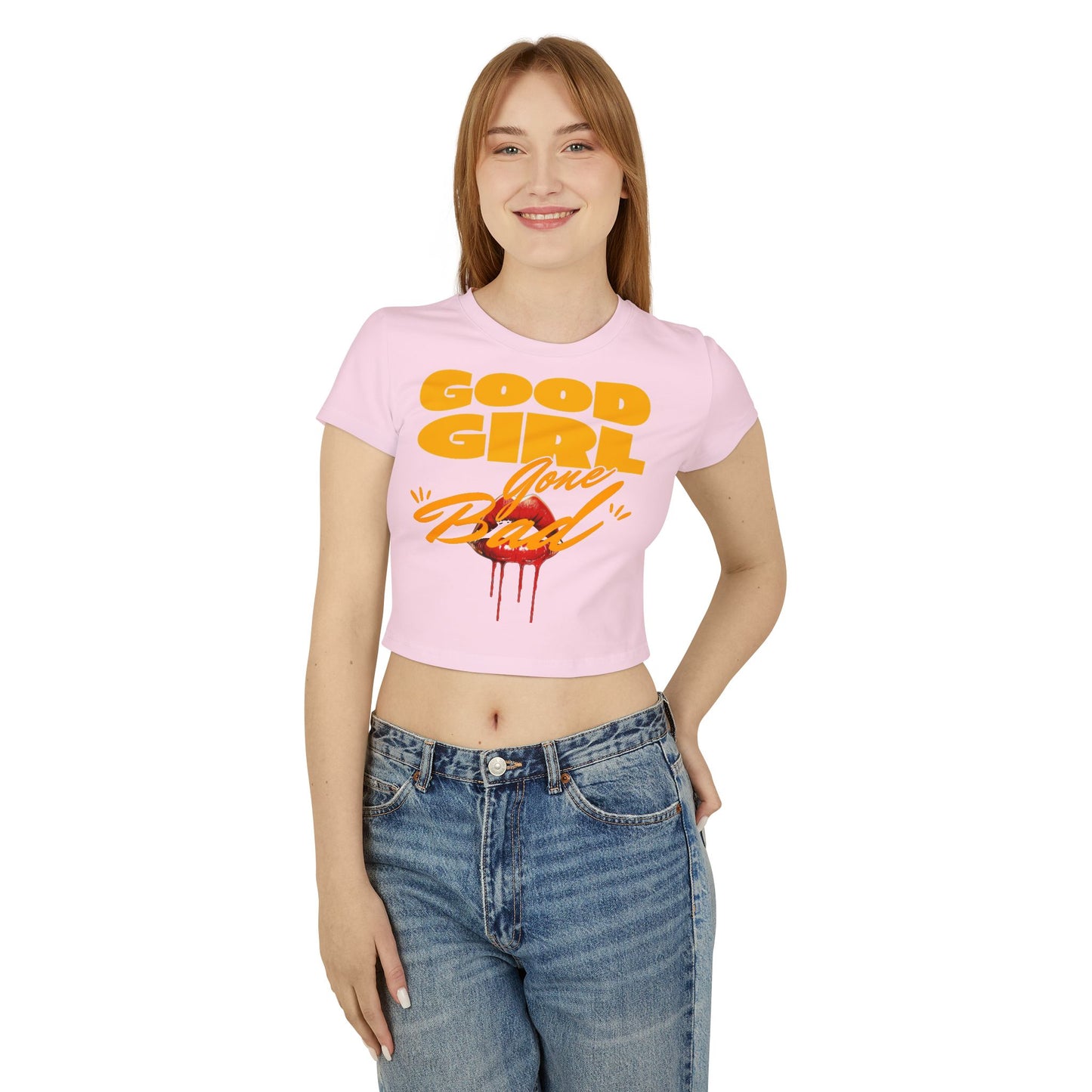 Model wearing a chic cropped Baby T-shirt in pink, featuring striking typography and a daring lip graphic, embodying a playful yet sophisticated vibe ideal for any occasion.