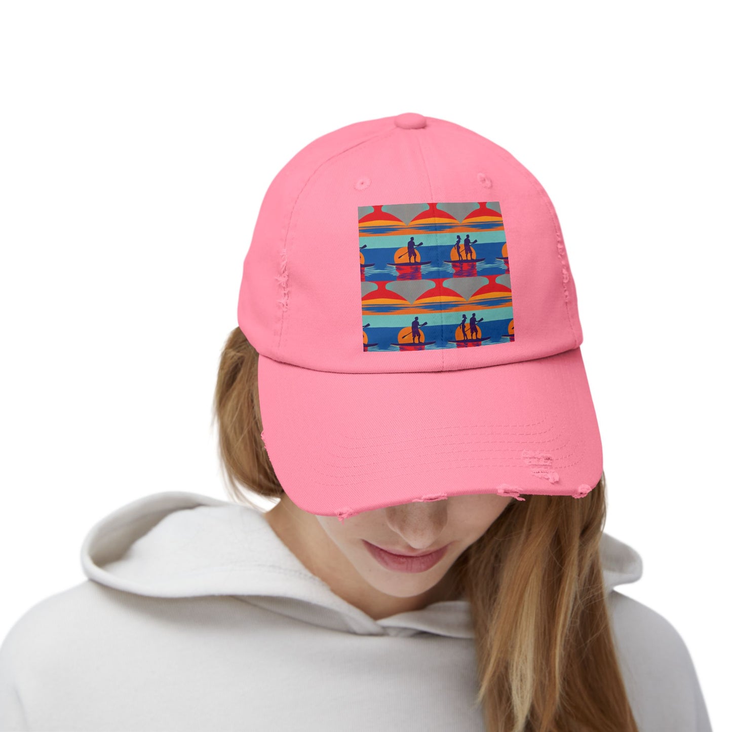 Front view of a Unisex Distressed Cap featuring a fantasy paddleboarding scene, worn by a model. The cap, in a stylish pink colour, is ideal for both men and women who embrace their adventurous spirit.