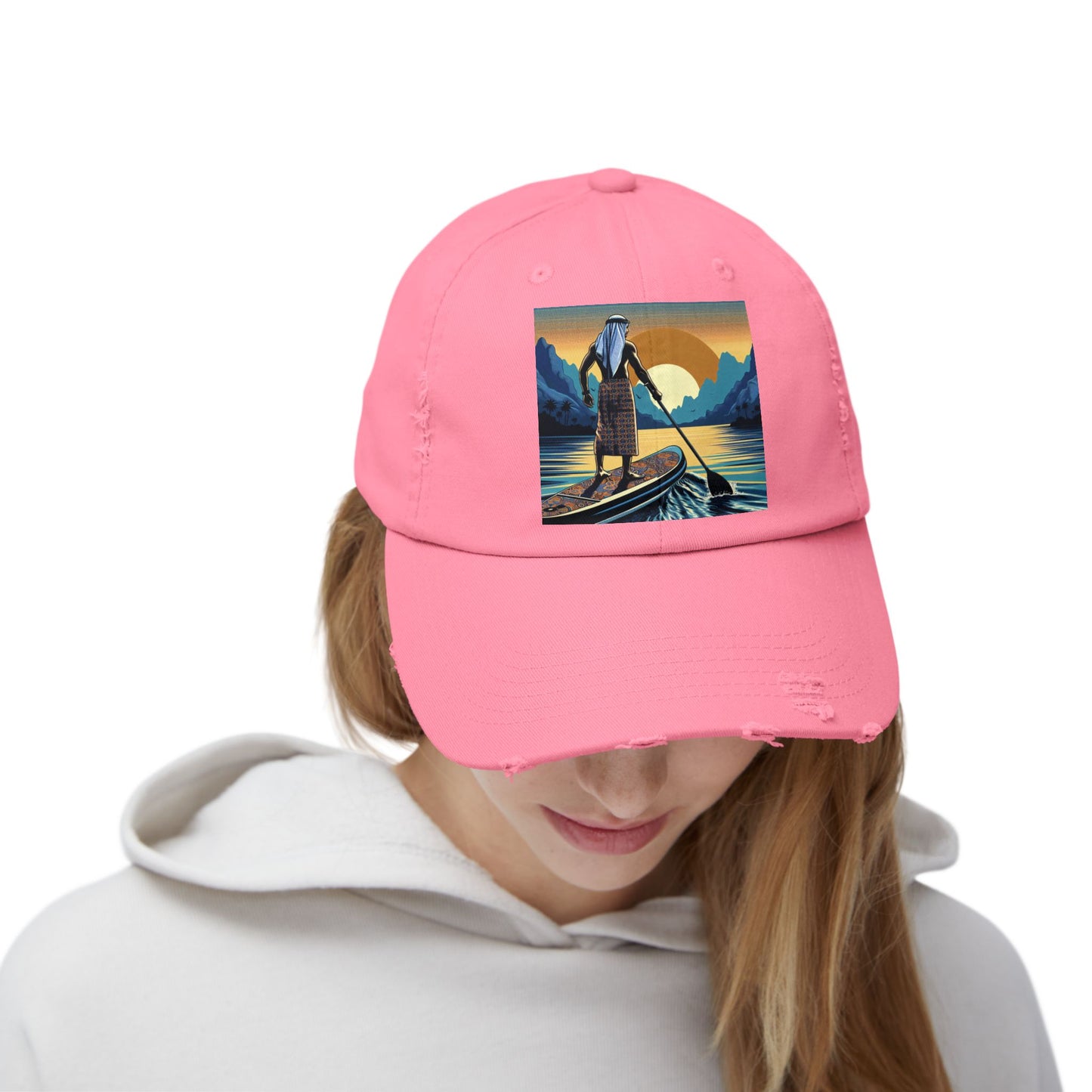 Unisex Distressed Paddleboarders Cap worn by a model showcasing the vibrant pink colour and paddleboarding design, perfect for summer adventures.