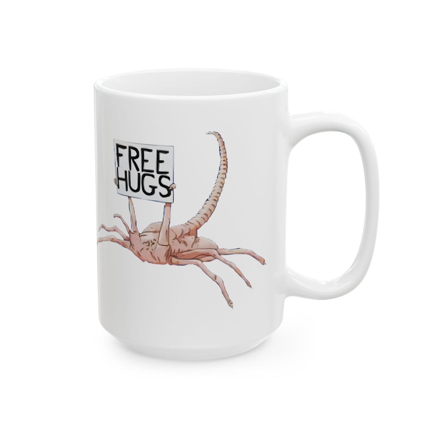 Alien Xenomorph Facehugger Free Hugs Funny Ceramic Mug placed on a desk next to a steaming cup of coffee, inviting laughs and conversation with its quirky facehugger character.