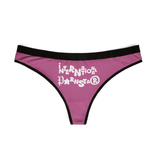 Front view of the sophisticated INTERNATIONAL PORSTAR™ Women's Thong featuring whimsical text on a pink background, designed for the confident woman.