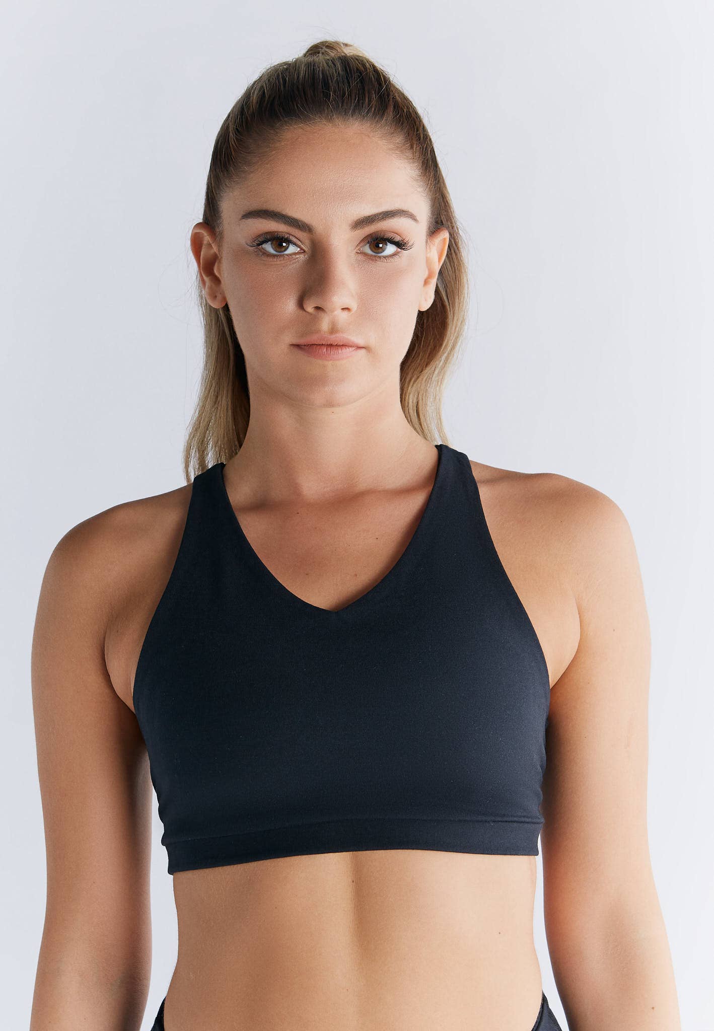 Stylish display of the luxury organic cotton sports bra, accentuating its figure-hugging cut and padded support, ideal for both active and casual settings.