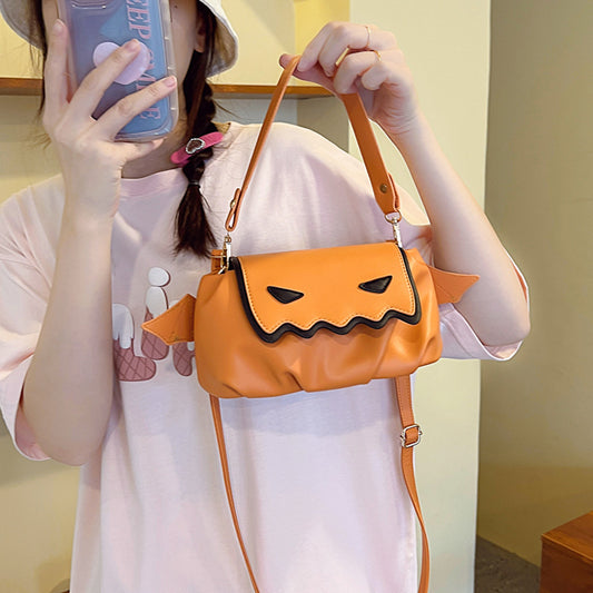 Versatile PU Crossbody Bags for Women - Trendy Orange & Black Halloween Style, displayed on a model in a pink T-shirt with a bucket hat, holding the bag.