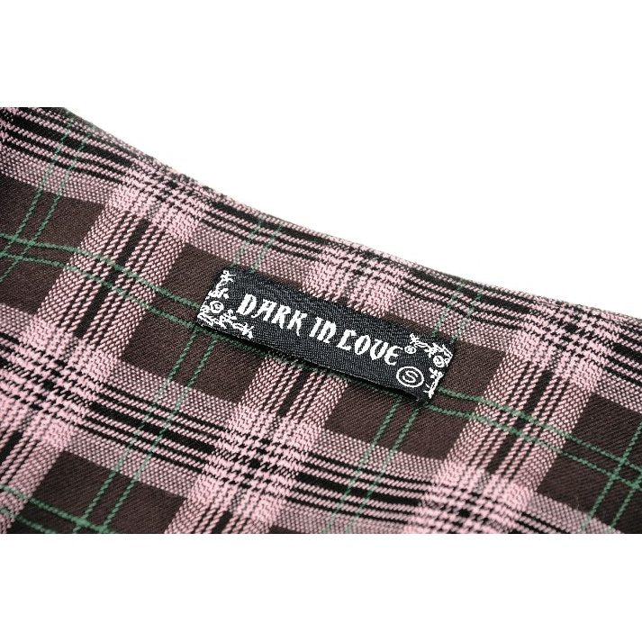Close-up view of the Dark In Love Rowan Mini Skirt fabric, featuring a chic pink and black plaid pattern with a rebellious studded belt, ideal for alternative fashion enthusiasts.