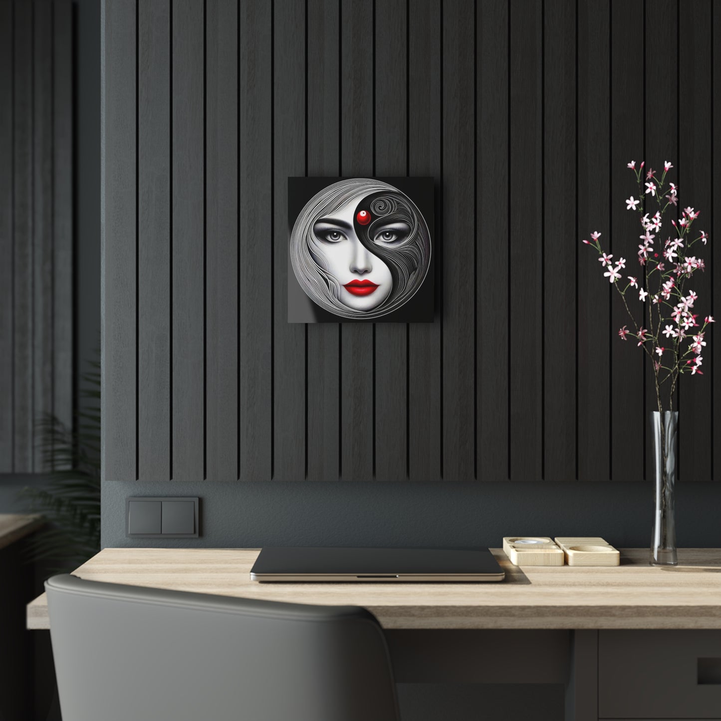 Yin-Yang Acrylic Print - Artful Expressions, a luxurious 12-inch abstract wall art featuring a stylised woman's face with flowing black and white lines, a striking red dot on her forehead, and bold red lips, displayed elegantly against a chic interior setting.