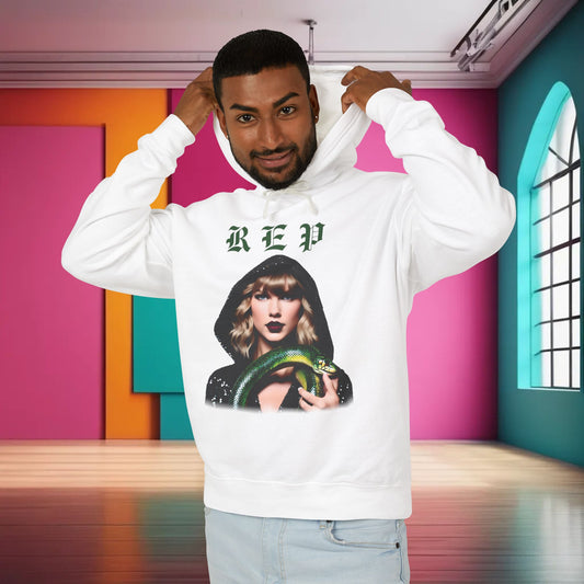 Stylish unisex cotton hoodie for Swifties in white, displaying a striking design of Taylor Swift with a green snake, ideal for fans who appreciate luxury and comfort.