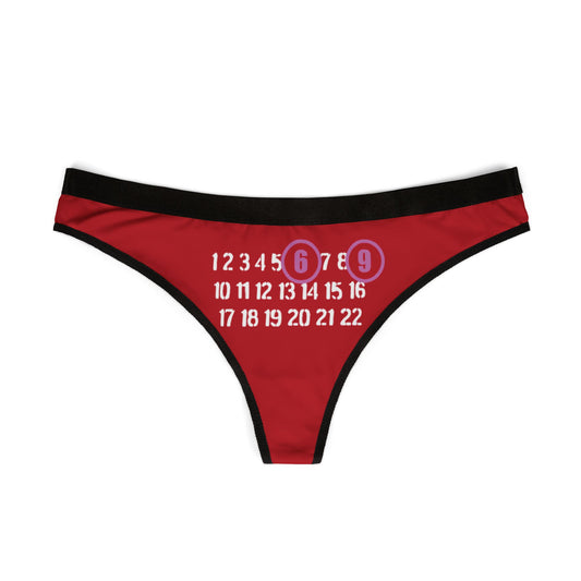 Luxurious red thong featuring a playful design with the bold numbers '6' and '9' highlighted in pinkish-purple, surrounded by a series of elegant white numbers.