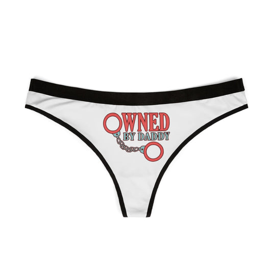 Stylish white women's thong with a bold 'Owned By Daddy' graphic, designed to blend humour and luxury for an alluring statement.