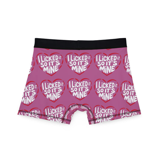 Valentine's Naughty Cheeky Men's Boxer Briefs viewed from the back, featuring a playful design with 'I LICKED IT SO IT'S MINE' in eye-catching red hearts on pink fabric.