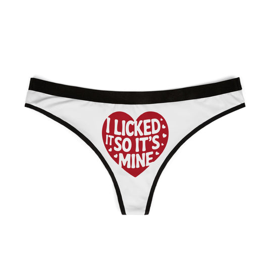 Chic women's thong displaying the humorous slogan 'I Licked It So It's Mine' adorned with a striking red heart, designed for luxury and comfort, ideal for romantic gifting or fun-loving lingerie collections.