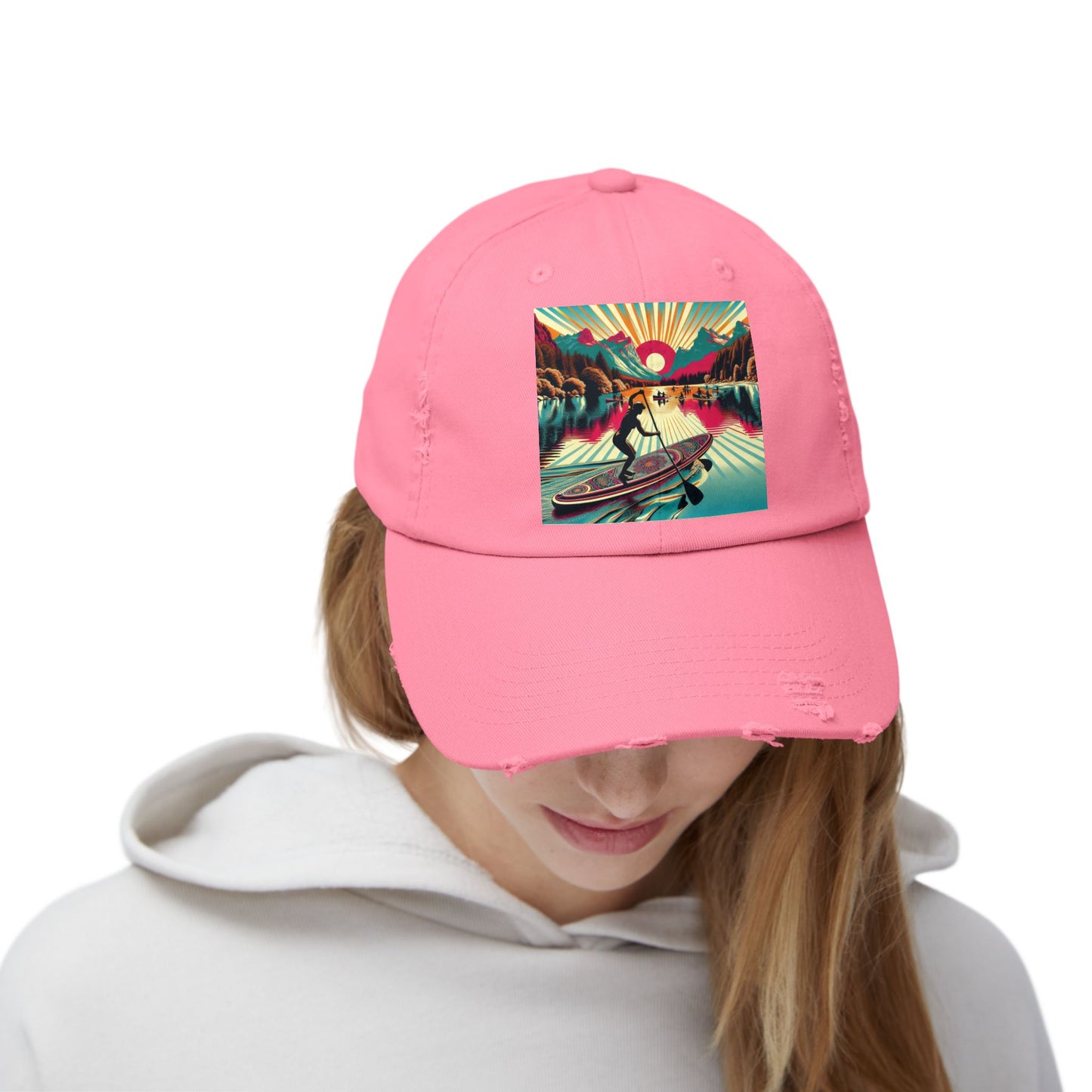 Model wearing the Unisex Distressed Paddleboarders Cap in pink with an eye-catching fantasy design, perfect for adventurous outings and outdoor elegance.