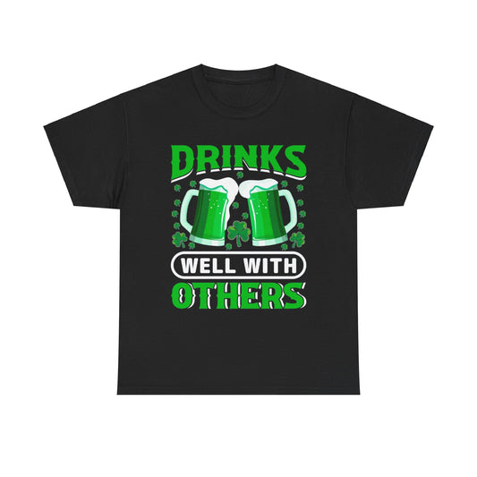 Funny St. Patrick's Day Unisex T-Shirt featuring 'Drinks Well With Others' and Irish beer mug design in vibrant green and black, perfect for festive celebrations.