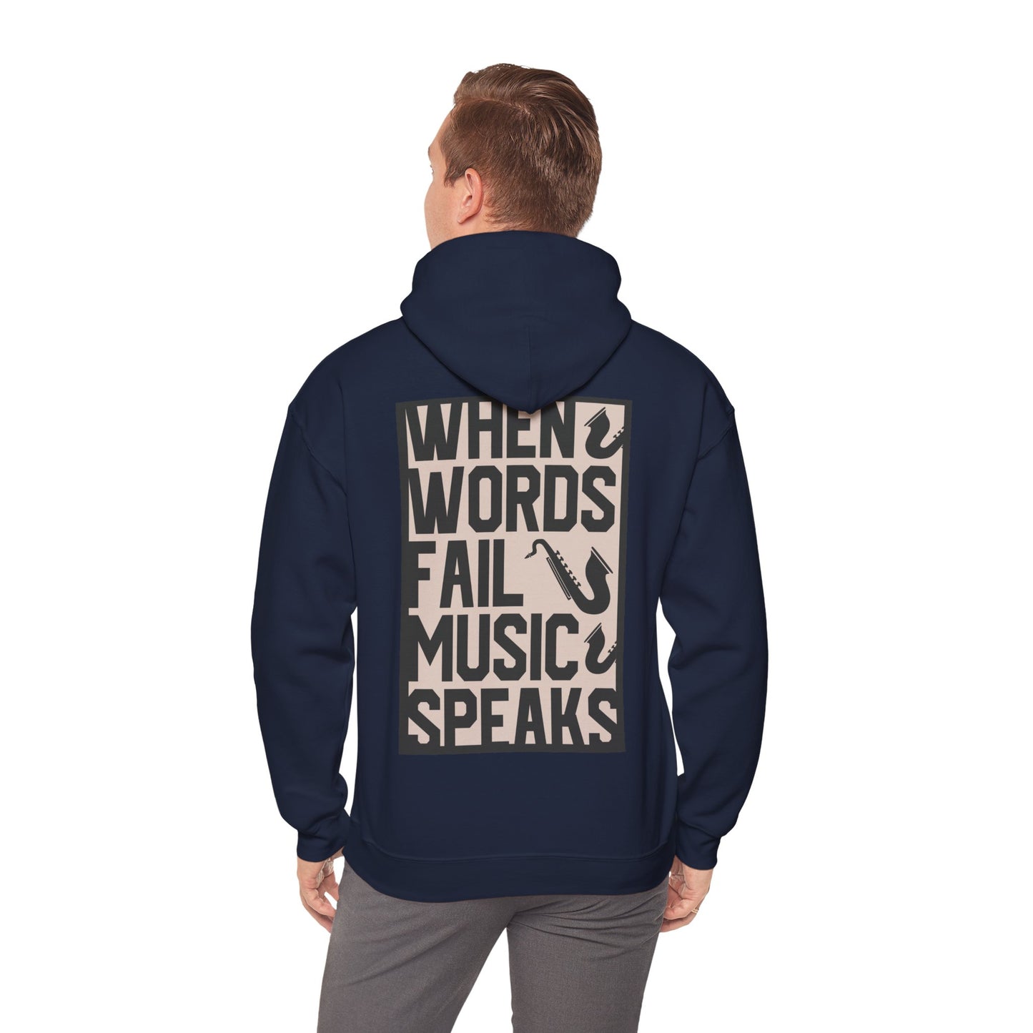 Model showcasing a chic navy hoodie, conveying a stylish vibe with the powerful phrase 'WHEN WORDS FAIL MUSIC SPEAKS' and saxophone designs on the back.