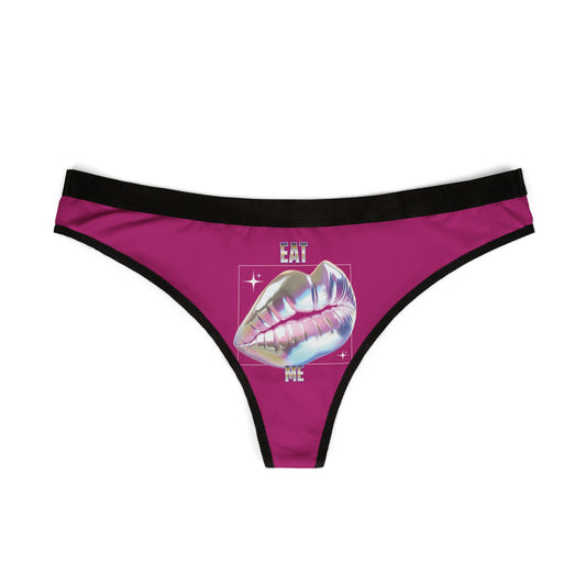 Elegant women's thong displaying a striking design of holographic lips with 'EAT ME' lettering, crafted for comfort and style in a bold magenta hue.