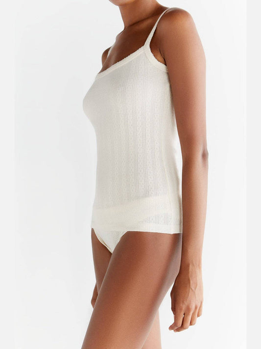 Elegant jacquard fabric close-up of a natural-coloured women's vest, crafted from 100% organic cotton, highlighting its premium quality and texture.