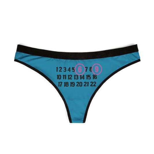 A stylish 69 thong displayed flat, highlighting the playful design with bold black typography and vibrant pink circles around the numbers 6 and 9.