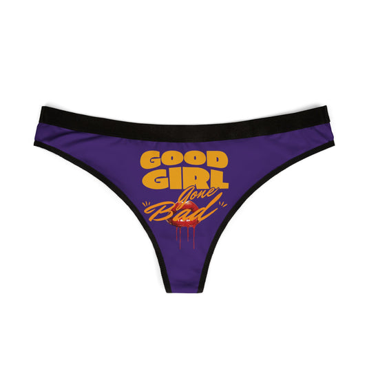 Chic purple thong displaying the eye-catching 'Good Girl Gone Bad' lettering in vibrant hues, complemented by sultry red lip detailing.