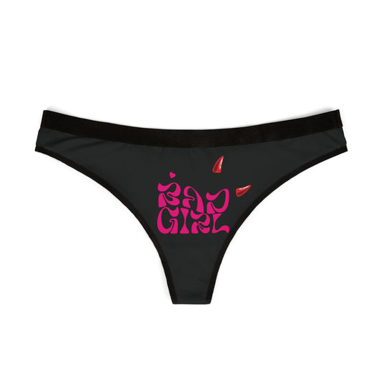 Elegant black thong design showcasing a striking hot pink 'Bad Girl' typography adorned with red devil horns, perfect for adding a naughty touch to your lingerie collection.