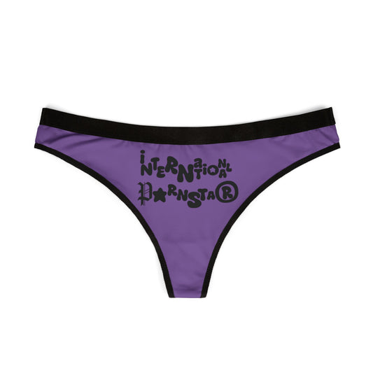 Front view of a chic women's thong with the phrase 'International Star' in bold black typography on a stylish purple background, perfect for fashion-forward lingerie.