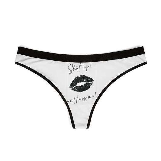 Stylish white thong with black trim, showcasing a cheeky graphic that reads 'Shut Up! and kiss me!', ideal for adding fun to intimate moments.