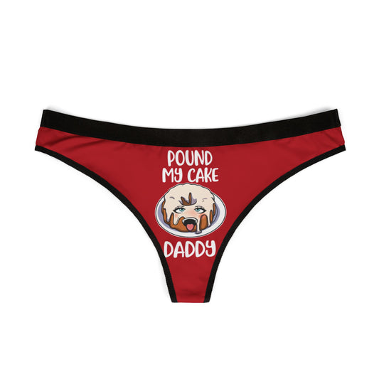 Elegant red women's thong adorned with a whimsical cake illustration and the cheeky text 'POUND MY CAKE DADDY', designed for playful and flirtatious moments.
