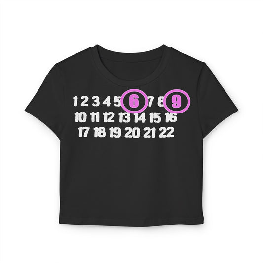 Chic black cropped t-shirt adorned with a whimsical number pattern, showcasing highlighted 6 and 9 for a fun, stylish statement.