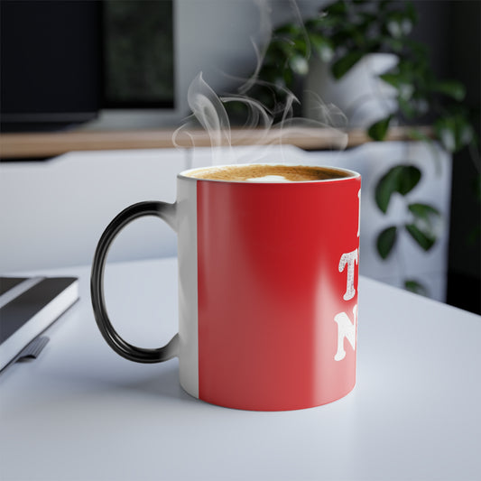 Let It Snow Le Tits Now Christmas Color Morphing Mug filled with a hot beverage, exuding warmth and a playful spirit, ideal for holiday gatherings.