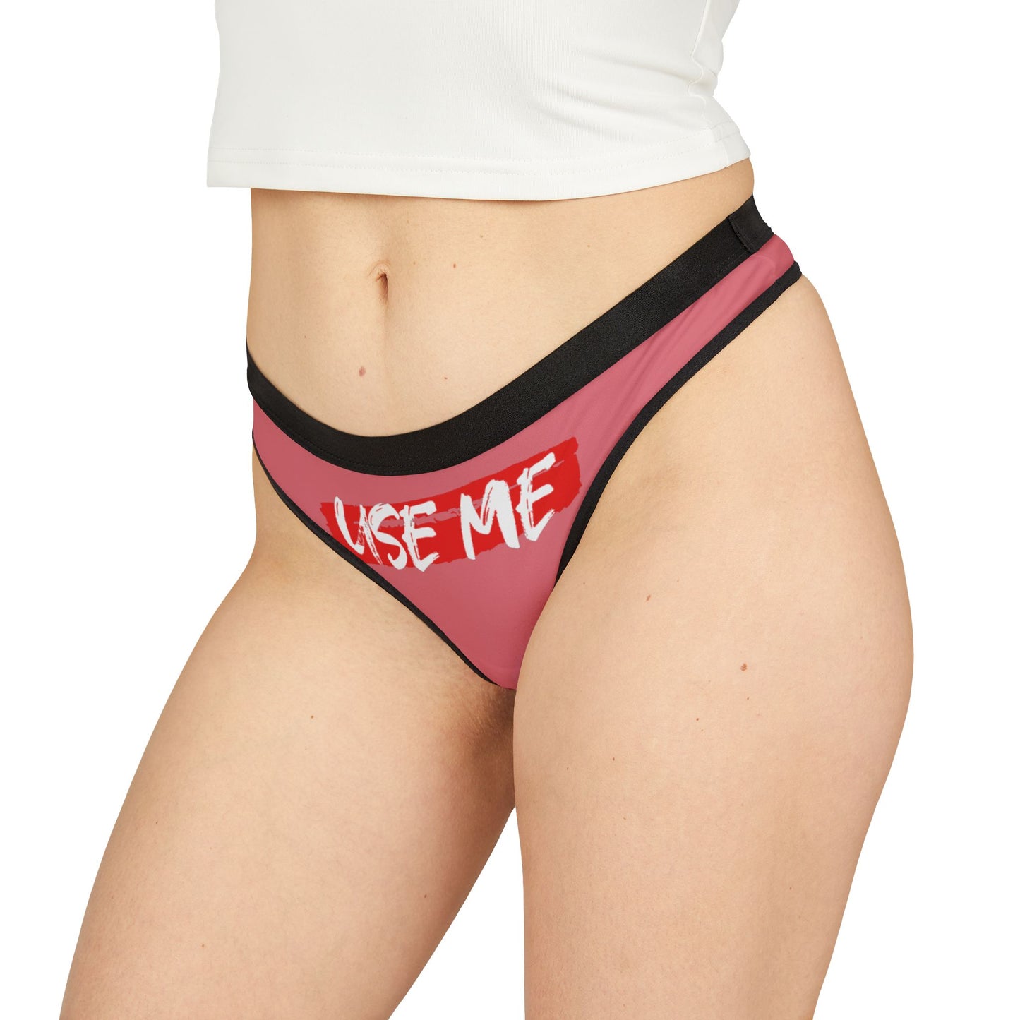 Chic and bold dusty rose thong with the daring inscription 'USE ME', embodying a fun and confident spirit suitable for adventurous intimates.