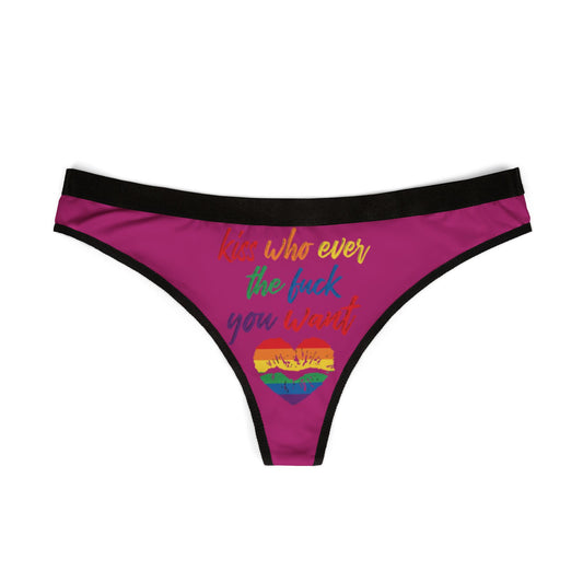 Elegant pink thong showcasing the cheeky phrase 'Kiss whoever the fuck you want,' beautifully complemented by a rainbow heart graphic, ideal for bold and playful romantic occasions.