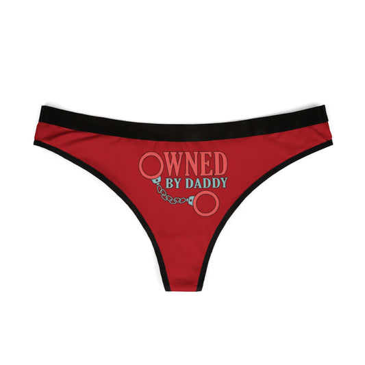 Luxurious red women's thong lingerie featuring the playful text 'OWNED BY DADDY' with graphic handcuff design, adding a touch of cheeky romance.