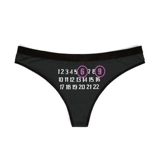 Elegant black thong with cheeky '6' and '9' numbers prominently displayed, crafted for comfort and allure.