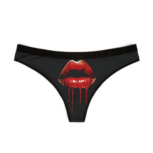 Elegant women's thong in black showcasing a bold design of glistening red lips and dripping detail, ideal for adding a cheeky touch to special moments.