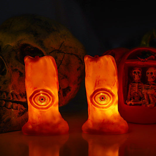 Halloween Blood Eye Lamp LED Electronic Light-emitting Candle Light displayed against a dark backdrop, illuminating two eerie candle designs that create an elegant yet terrifying ambiance.