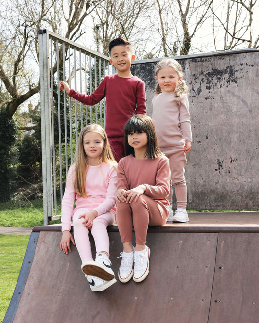 Soft pink family matching pyjamas set for adults and kids from DreamBuy, showcasing their luxurious cotton fabric, perfect for cozy nights.