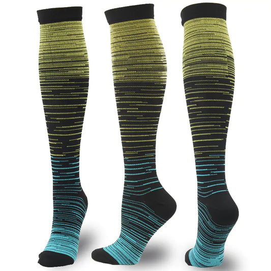 A close-up view of Men's and Women's activewear Flightwear Compression Stockings and Socks featuring a striking gradient pattern in vibrant yellow and blue, perfect for enhancing athletic performance.