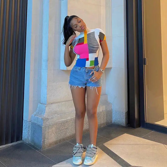 Keep It Real Slim Fit Mock Neck Tee with Bold Abstract Print - Cropped & Stretchy Design displayed on a stylish model, paired with denim shorts and playful sneakers, highlighting its unique print and luxurious fit.