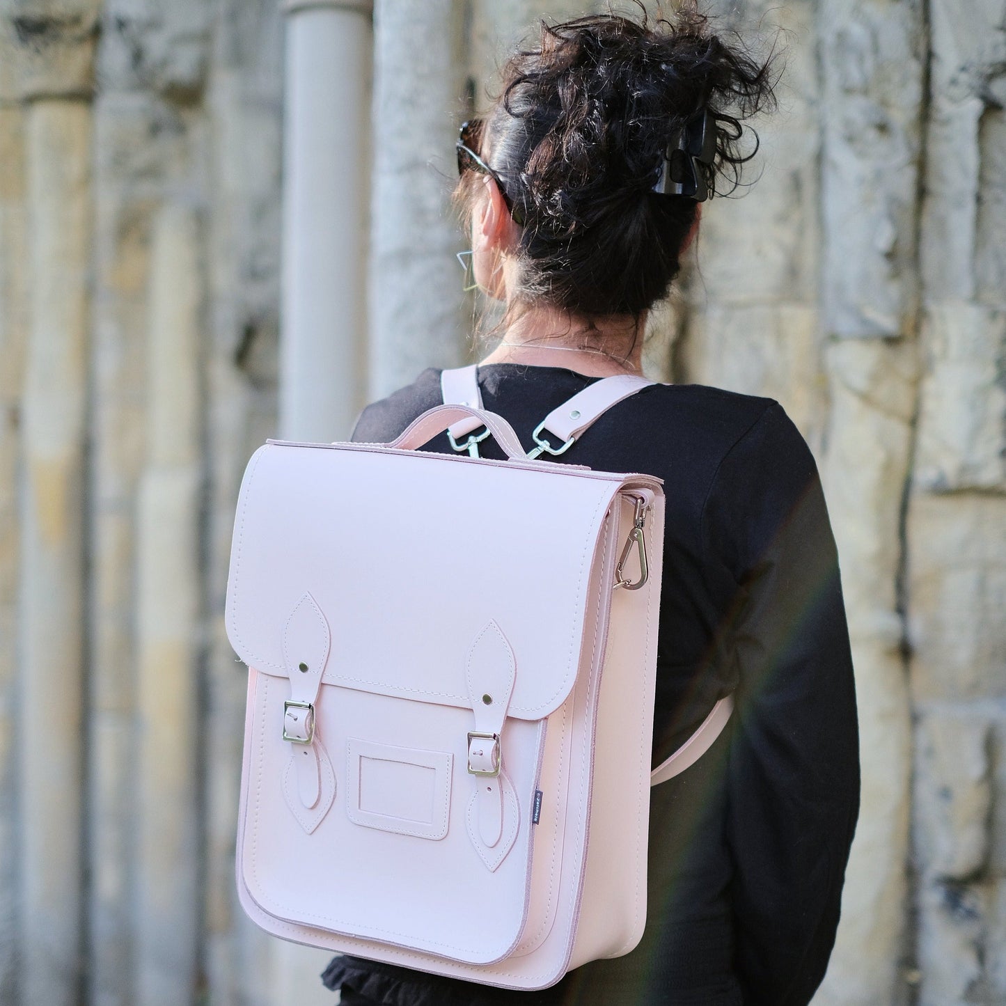 Stylish Handmade Cherry Blossom Leather City Backpack displayed in urban setting, highlighting its versatile carrying options and exquisite craftsmanship.