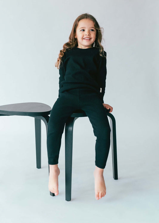 Elegant black matching pajamas for families by DreamBuy, showcasing a blend of comfort and classic design in high-quality cotton, ideal for gifting and family moments.