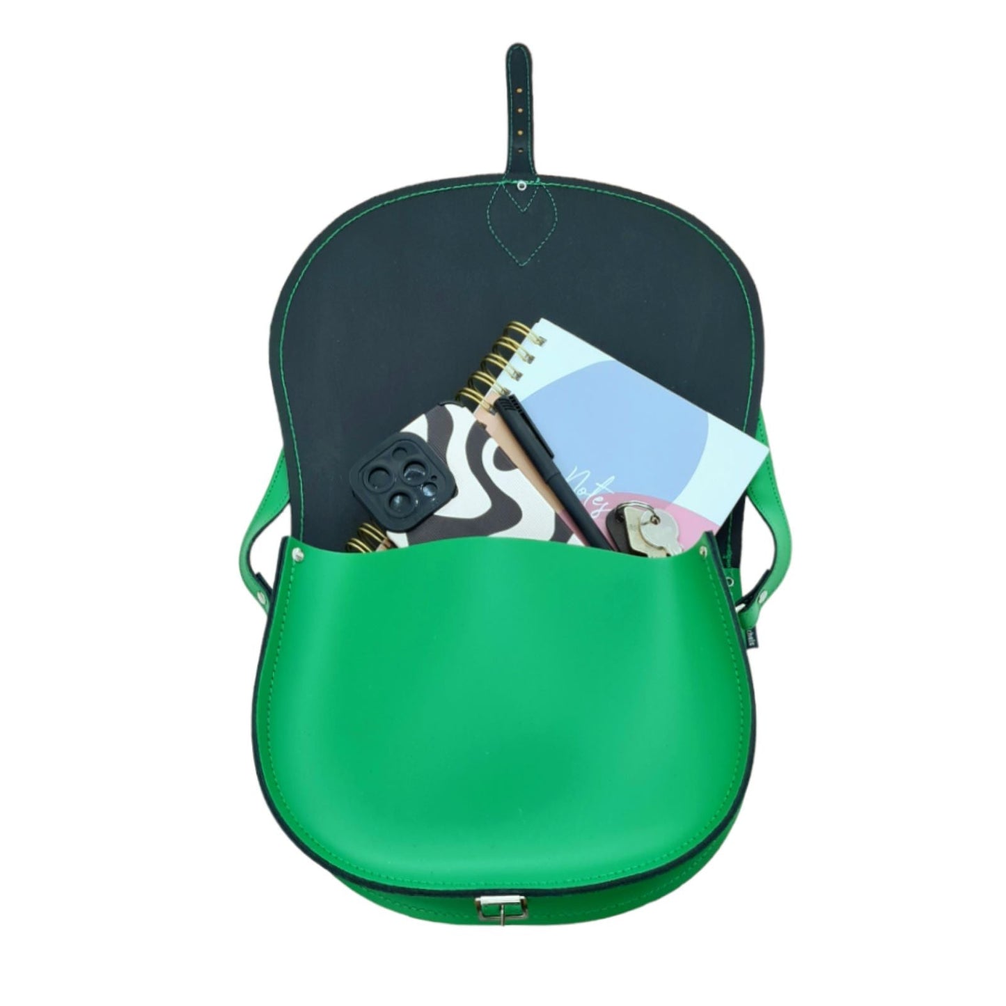 Handmade green leather saddle bag showcasing adjustable crossbody strap, available in two sizes with custom engraving option, highlighting premium craftsmanship and timeless elegance.