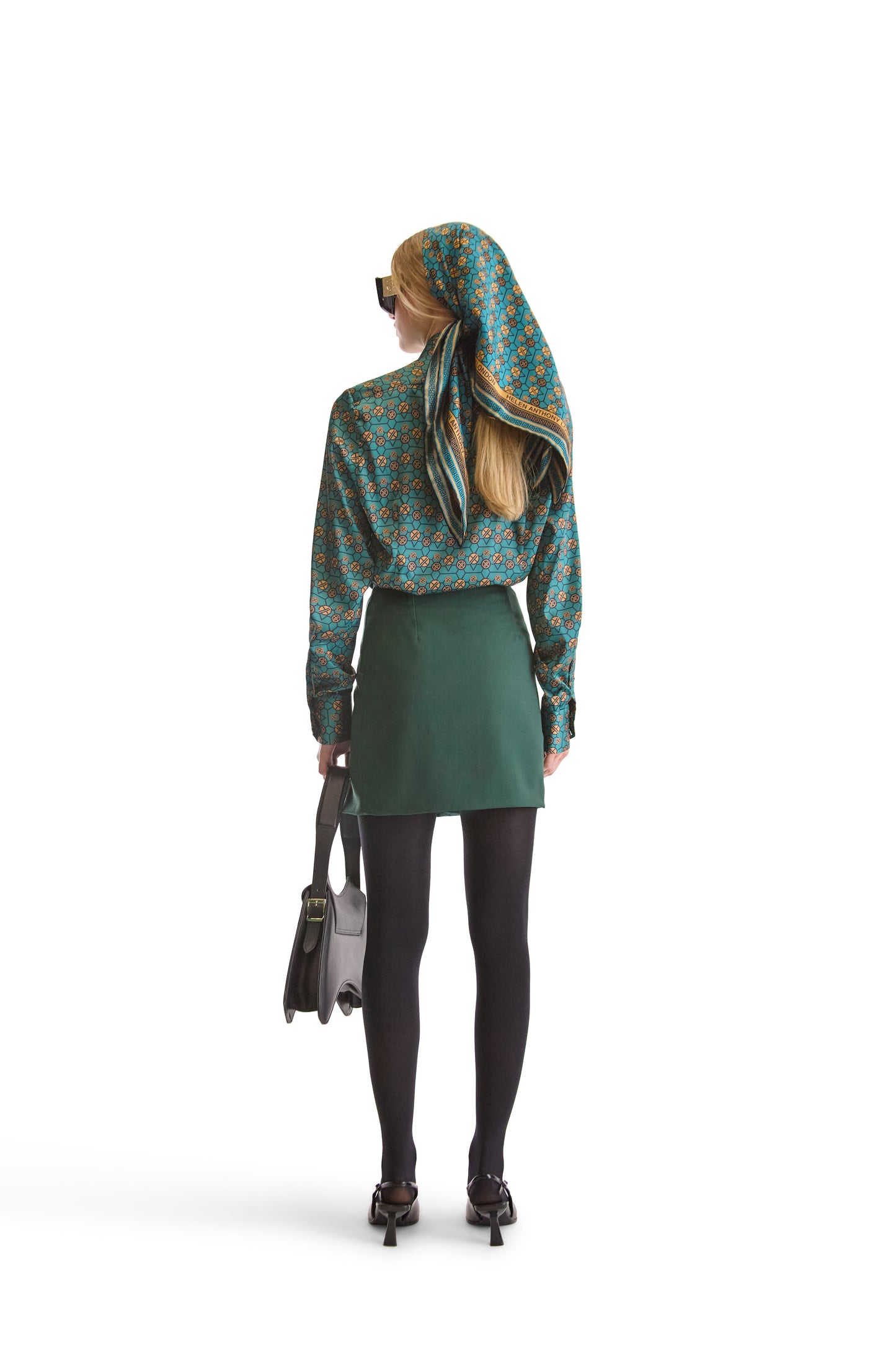 Elegant presentation of Helen Anthony's exclusive geometric monogram silk scarf on a stylistic background, embodying Italian luxury.