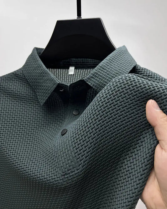 Men's AirElegance Polo Tee Moisture wicking Breathable, featuring a sophisticated dark grey fabric with modern textured design and refined collar details.